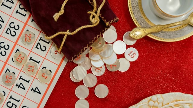 Bingo cards and calling chips spilled from a pouch
