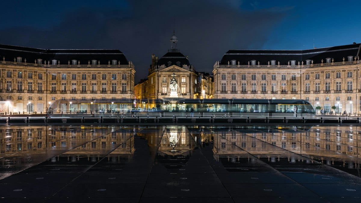 a reflection of a building in a body of water