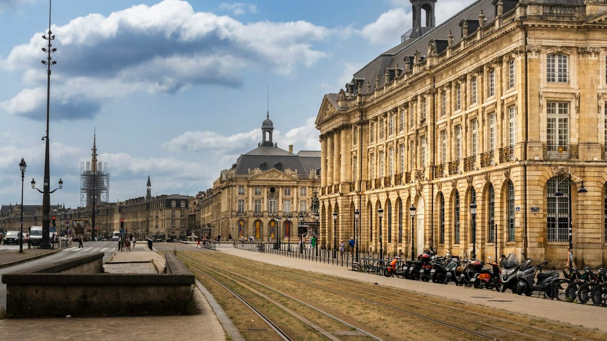 Historic european city square with grand architecture and tram tracks
