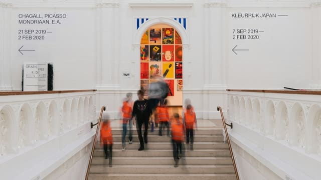 a group of people walking up a flight of stairs