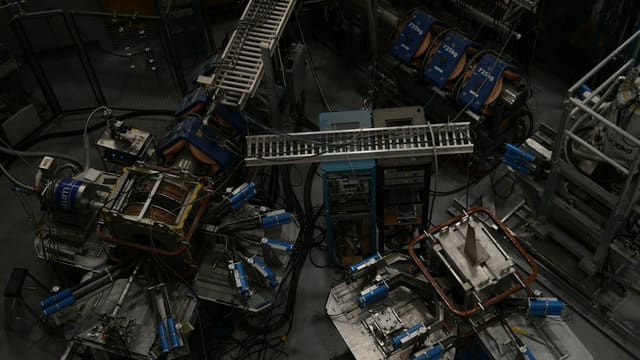 Intricate industrial machinery and scientific apparatus from above